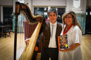 Author and Harpist holding Cookbook